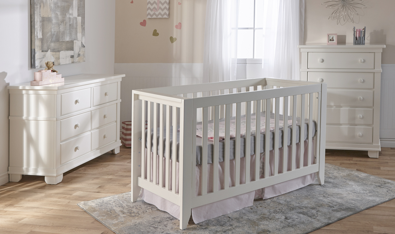 The <b>Spessa Crib</b> is traditional elegance that echoes simpler times with a touch of midcentury styling. Here shown with the 1306 Torino Double Dresser and the 1305 Torino 5 Drawer Dresser, in White.